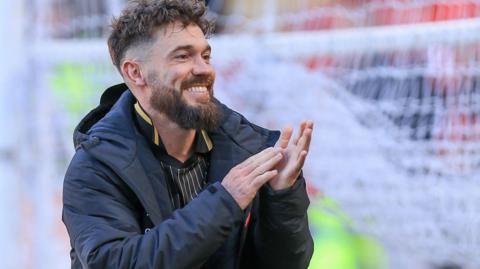 Tom Bradshaw claps the fans at the end of a Barnsley game