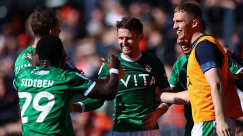 Ollie Norwood (centre) celebrates equalising for Stockport County at Luton