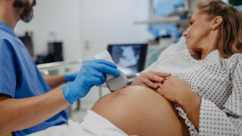 A pregnant woman being scanned 