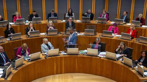 A general view of the Senedd's debating chamber in Cardiff Bay, with Vaughan Gething stood and speaking in the centre of it