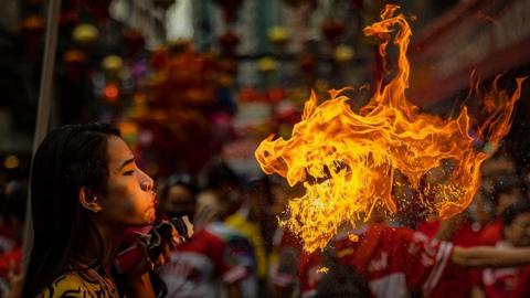 A performer breathes fire during Lunar New Year celebrations at Binondo district, in Manila, Philippines.