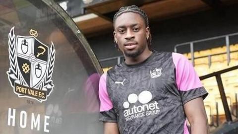 Ethon Archer leaning against the dug out in a Port Vale training top