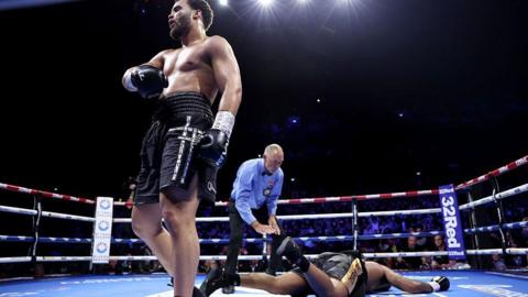 Moses Itauma celebrates with Jermaine Franklin on the canvas behind him