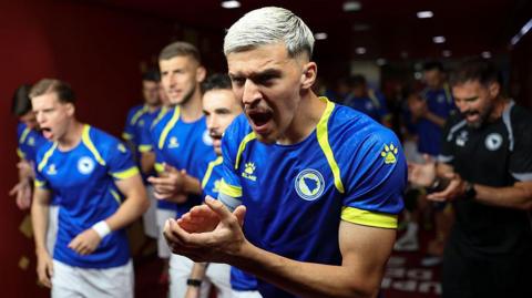 Tarik Muharemovic clapping his hands when walking out for Bosnia and Herzegovina 