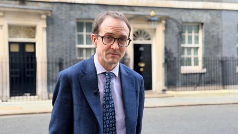 Chris Mason, wearing a blue suit, standing outside 10 Downing Street