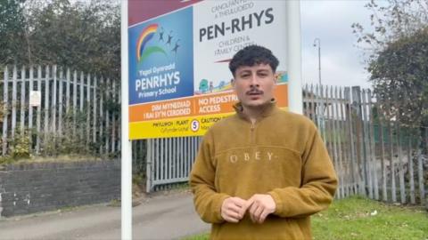 Reporter standing outside of Pen-Rhys Primary