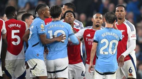 Arsenal and Manchester City players square up