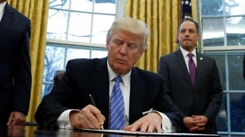 Donald Trump signs an order in the White House in 2017, during his previous presidential term