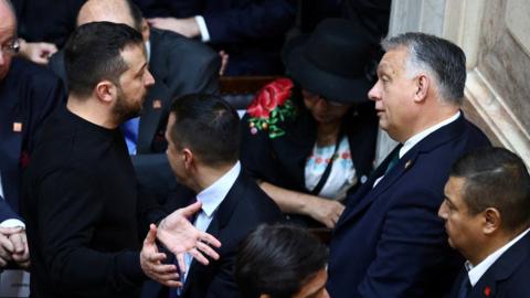 Hungarian Prime Minister Viktor Orban (R) speaks with Ukraine's President Volodymyr Zelensky at swearing-in ceremony of Argentina's President-elect Javier Milei in Buenos Aires, 10 Dec 2023