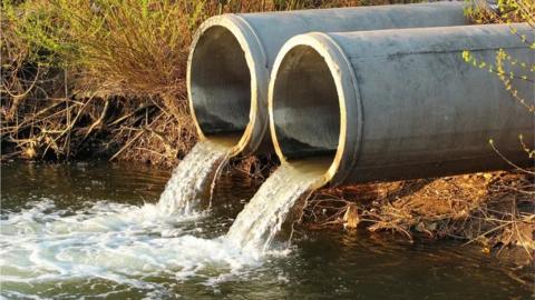 Stock image of treated water being put into a river