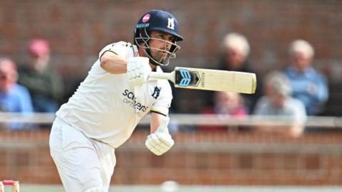 Warwickshire's Will Rhodes aims an aggressive drive