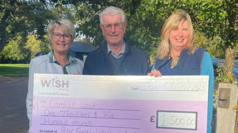 Peter Empson with daughters Beverley and Sandra, holding the cheque for My WiSH Charity