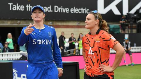 Hollie Armitage (L) of MI London tosses the coin as Dani Gibson of SunRisers Leeds watches