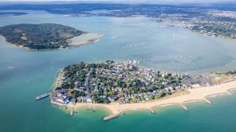 Aerial panorama view of Sandbanks Beach and Cubs Beach in Bournemouth, Poole and Dorset, England. Wide angle daytime.