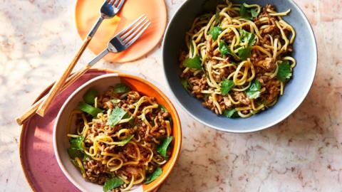 Two bowls of cumin pork noodles.
