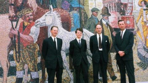 Created by artist Kenneth Budd in 1966, the mosaic mural depicts the centuries old custom of horse trading in the area.