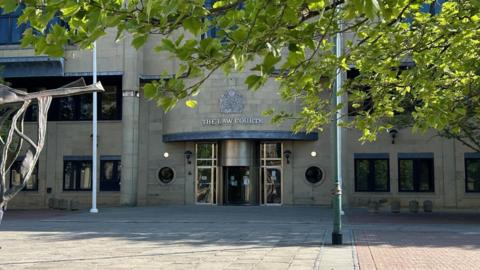 Bradford Crown Court: a stone building with silver writing above the front that says: The Law Courts