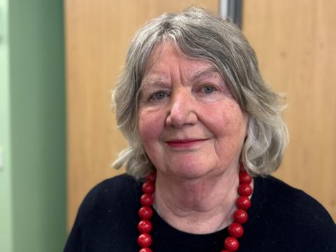 A head and shoulders photograph of Councillor Jill Makinson-Sanders. She is wearing a black top and has a necklace made of red beads.