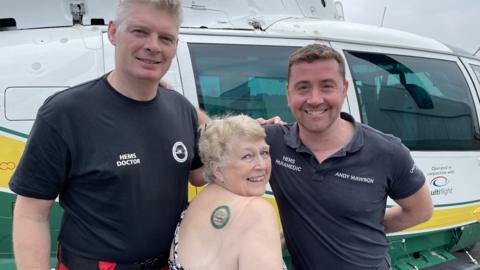 Sue Wilkinson with paramedic Andy Mawson and doctor Phil Godfrey from GNAAS