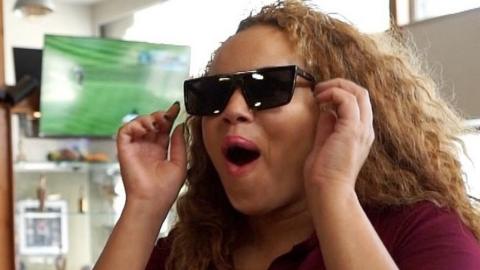Woman wearing sunglasses with surprised expression