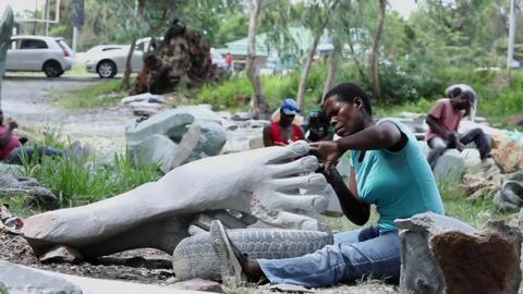 An artist working on the sculpture of a foot in Zimbabwe