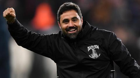 Vitor Matos raises his hand in celebration