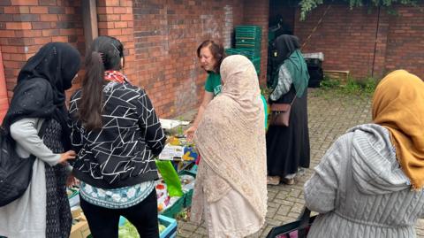 Women visiting Hull Sisters to collect food for their families