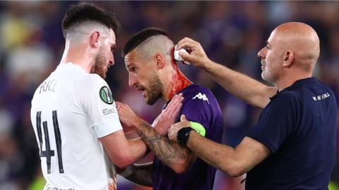 Cristiano Biraghi receives treatment for a head wound