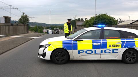 A police car in front of a crime scene