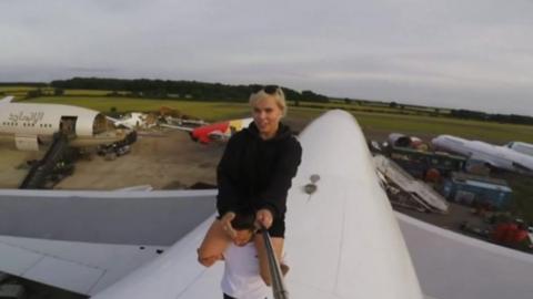 Woman on top of plane