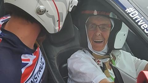 Manette Baillie behind the wheel of a Ferrari at Silverstone.