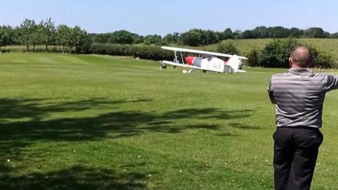 bi-plane lands on golf course