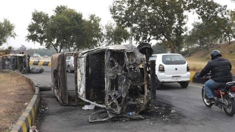 Destroyed police vehicle in Islamabad