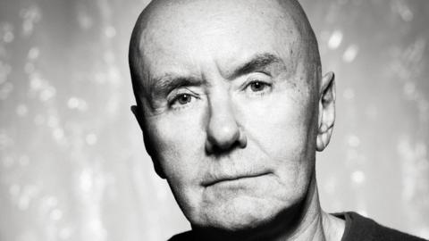 A press image of Scottish author Irvine Welsh in black and white 