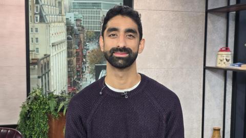 Dr Kas in the Morning Live studio, wearing a purple jumper.