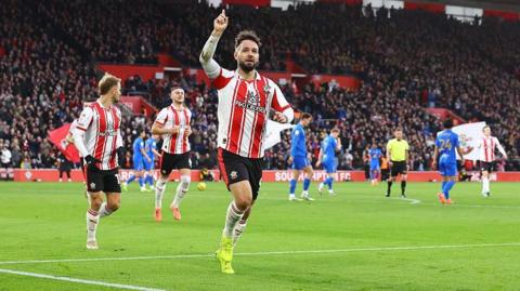 Adam Armstrong points to the sky after scoring for Southampton in their game against Birmingham City