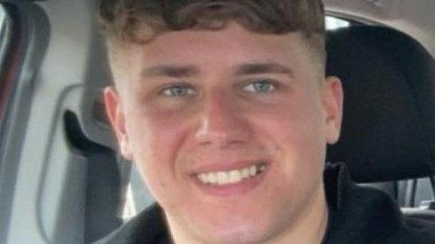 Close up image of young man sitting in a car