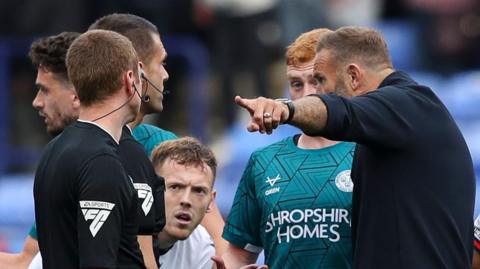 Bolton boss Ian Evatt argues with match officials and Shrewsbury players