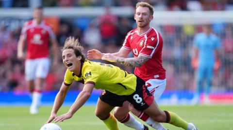 Watford's Edoardo Bove (left) and Wrexham's Lewis O'Brien battle for the ball