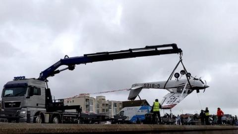 Wreckage of plane being lifted from beach at Lee-on-the-Solent