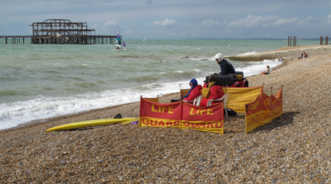 Lifeguards watching over a wind Brighton Beach and West Pier