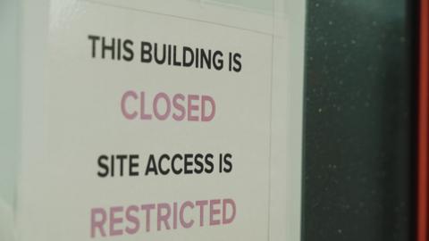 A sign that says This building is closed: Site access is restricted