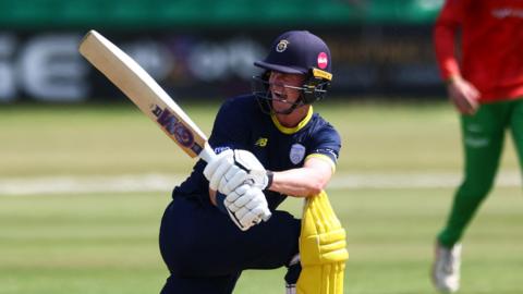 Nick Gubbins playing a sweep shot for Hampshire 