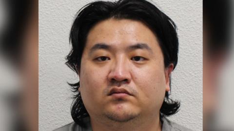 Chao Xu, a man with floppy dark hair, looks straight ahead into the camera.