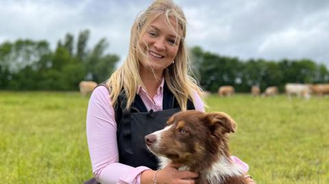 Harriet Cowan with her dog on a farm near Belper