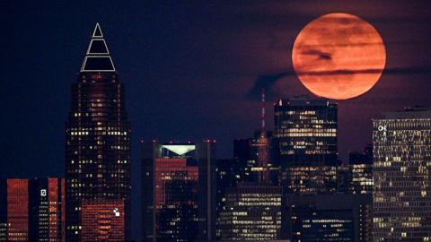 A red moon over the city skyline in Germany