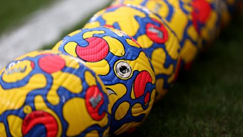 A line of Premier League footballs