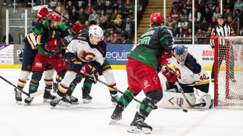 A Guildford Flames player has a shot at Cardiff Devils' net