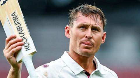 Marnus Labuschagne holds his bat aloft