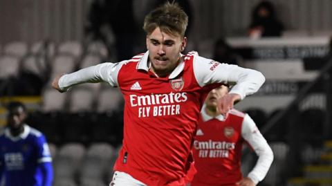 Billy Vigar in action wearing a red Arsenal shirt.